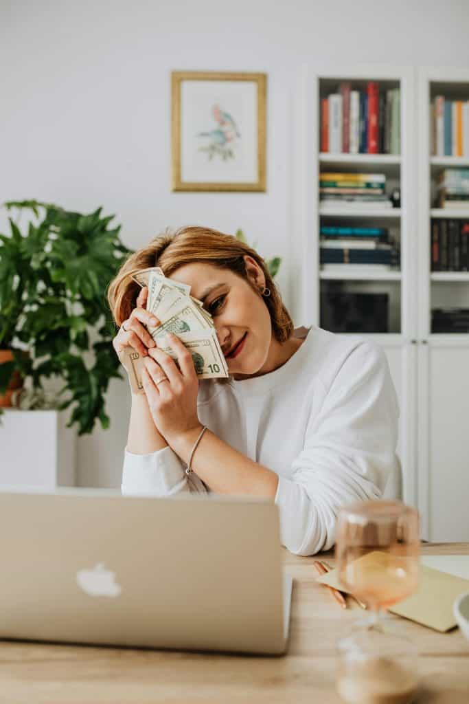 A successful blogger holding up money