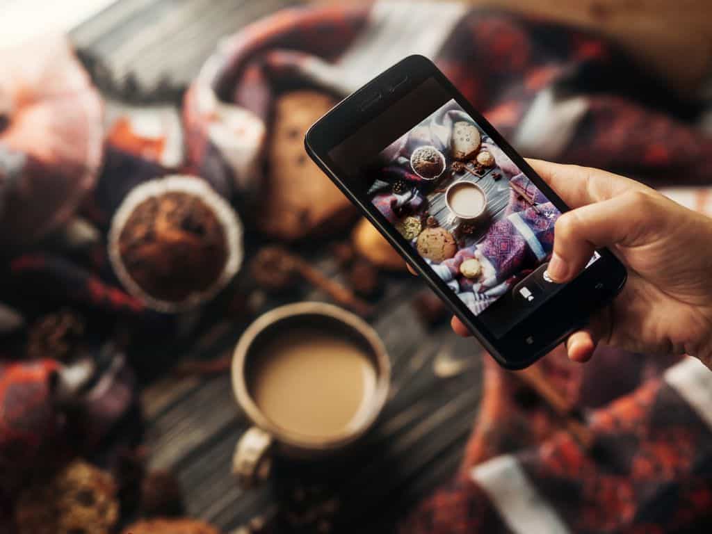 best Instagram songs: using a phone to capture coffee and pastries