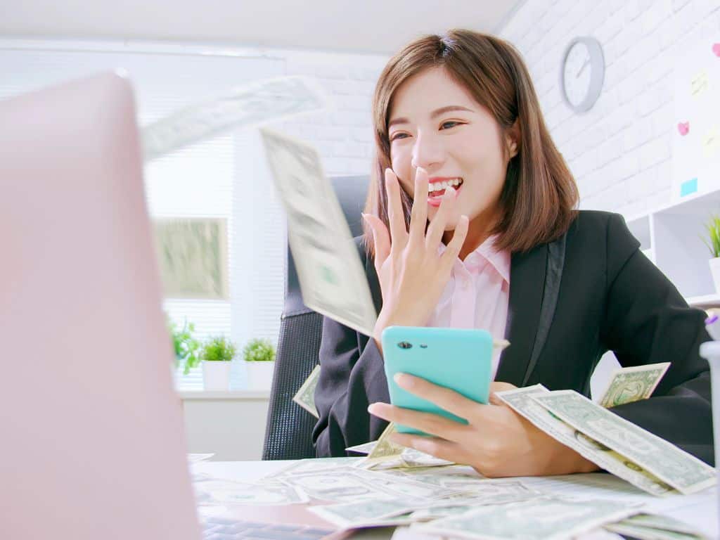 lady at laptop with money