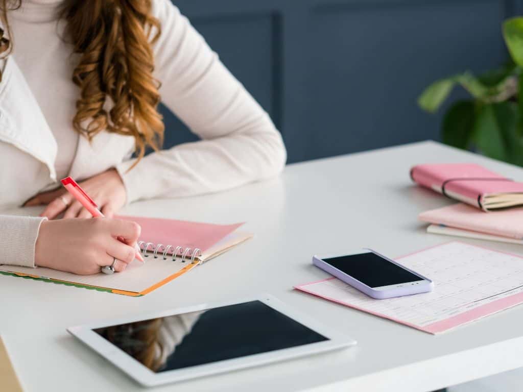 how to become a social media manager with no experience: girl writing in a book