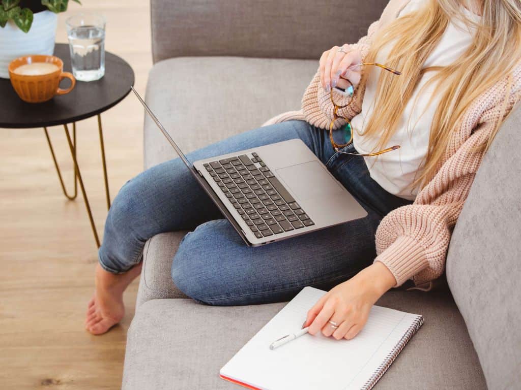 does remote mean work from home? lady on a sofa with her laptop