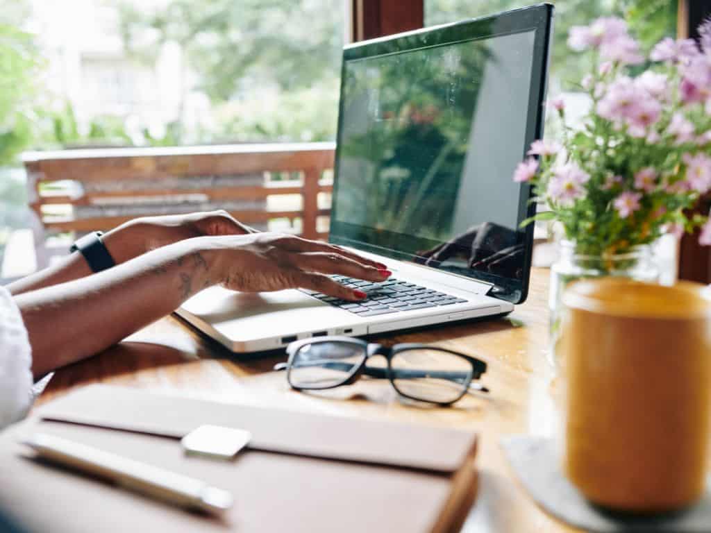 hands on a laptop with glasses