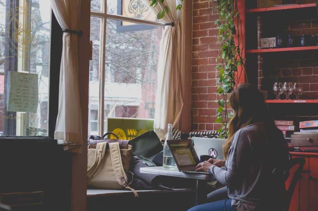 girl typing at her laptop