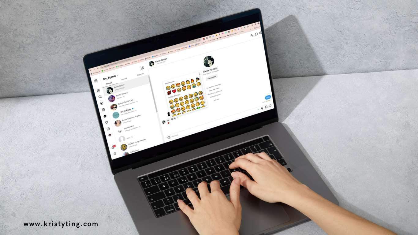 Hands typing on a laptop with a chat window and emoji selection visible.