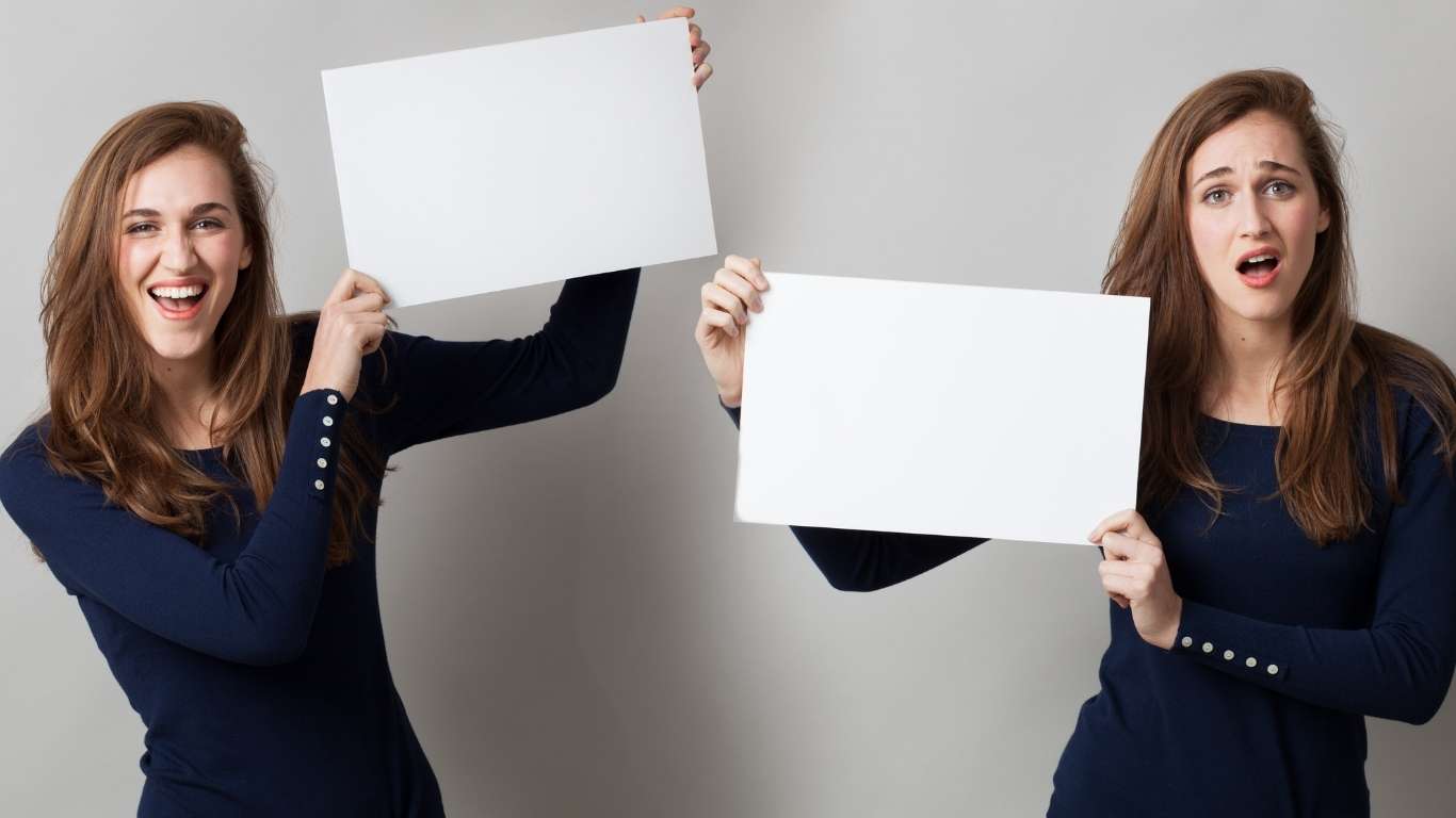 How To Pin A Comment On Instagram - Two women holding blank signs with different expressions.