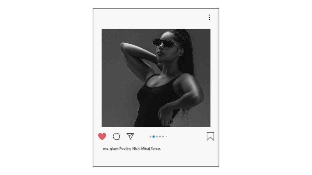 Black and white photo of a woman in sunglasses and a tank top, striking a fierce pose.