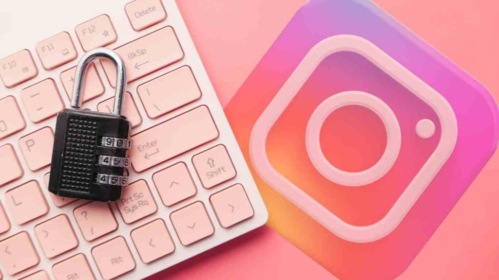 A padlock placed on a pink keyboard next to the Instagram logo, representing secure Instagram access and privacy protection.