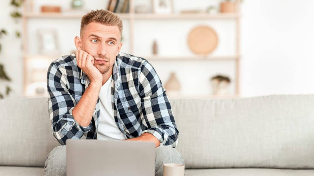 Man wondering what he should do as a newbie, sitting in front of his laptop