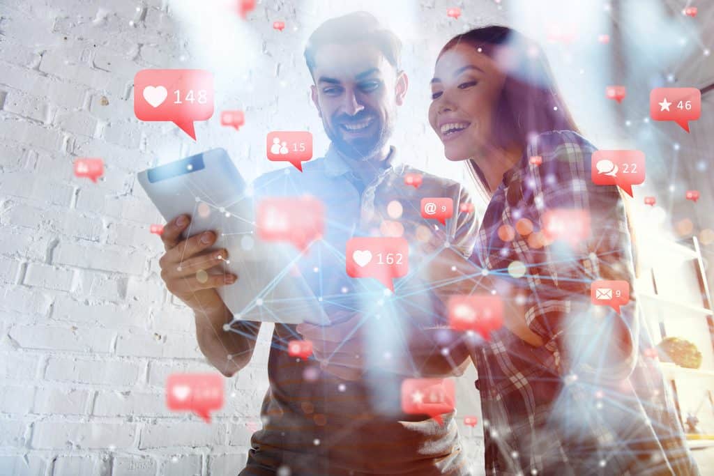 A couple looking impressed with the level of user engagement to their posts