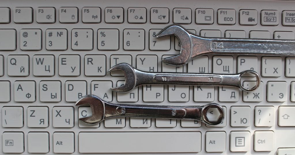 is freelancing free: wrenches (tools) for online work above a keyboard