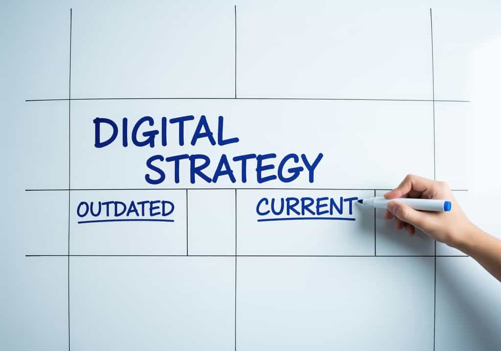 Digital Marketing Strategy Template: Hand writing digital strategy on a whiteboard, comparing outdated and current approaches for business development and marketing planning.