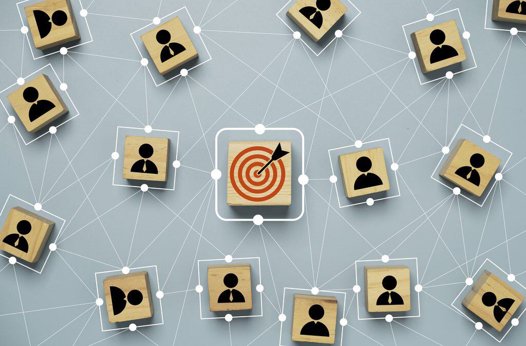 Digital Marketing Strategy Examples: Blocks Showing Connection Between People and a Bulls Eye Arrow on Target