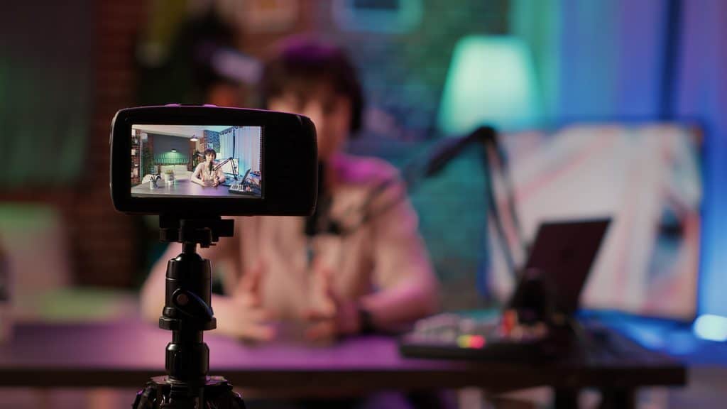 Digital Marketing Trends 2026: Someone recording himself behind a camera while at his desk