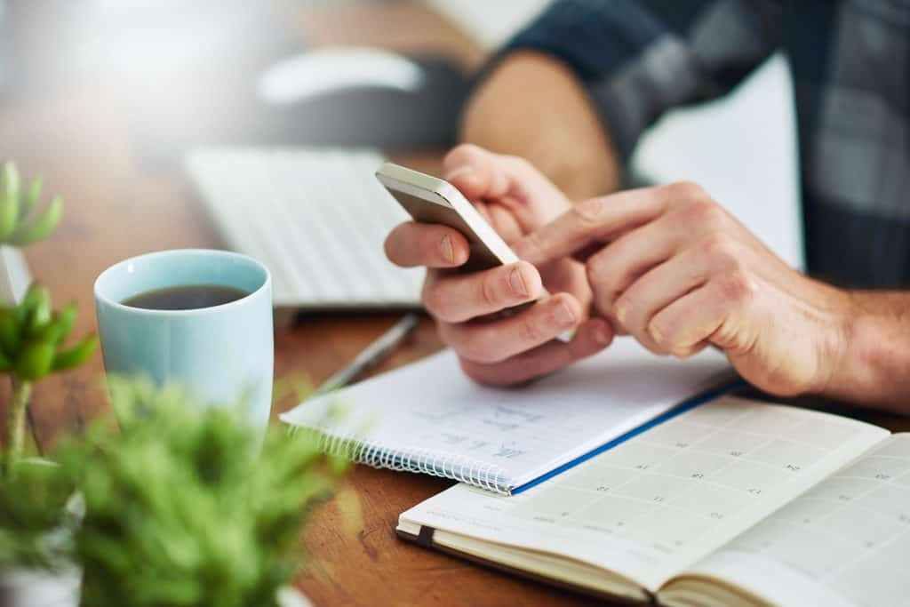 Freelancer researching customer reviews and notes before writing sales copy