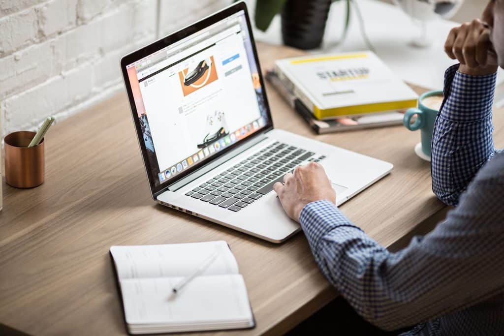 Freelancer reviewing a social media profile on a laptop, an example of social media manager portfolio work