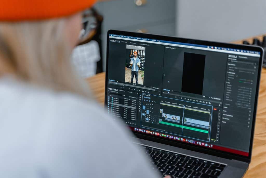 Person editing short-form video in Premiere Pro on a laptop, a skill shown in social media manager portfolio examples