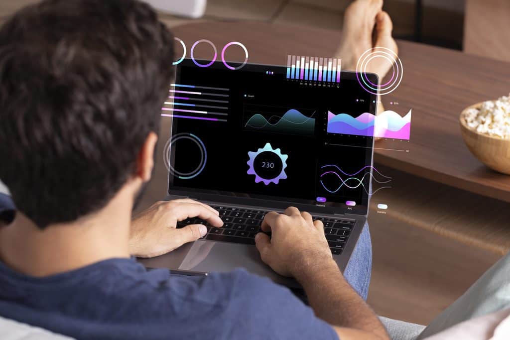 Person viewing an analytics dashboard on a laptop with charts and graphs