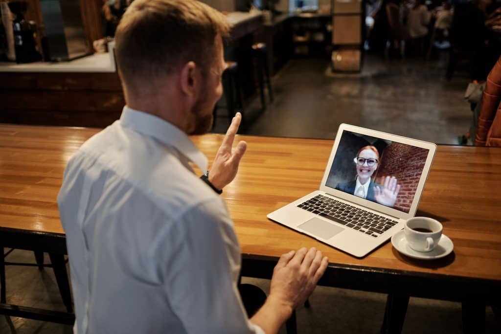 Freelance rates for beginners: A man having an online meeting with a female client