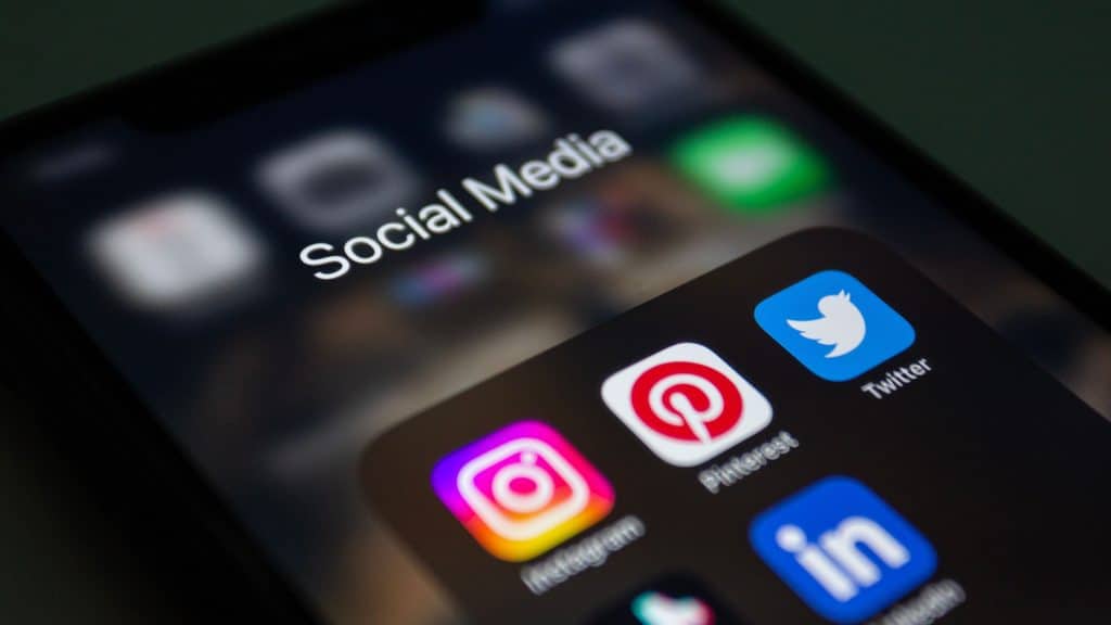 Smartphone screen showing Instagram, Pinterest, Twitter, and LinkedIn social media apps