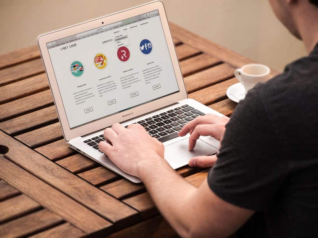 Person viewing a clearly laid-out services page on a laptop, an example of how to package freelance services online