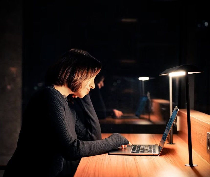 Is Upwork worth it? Image depicts a girl thinking, while working on a laptop