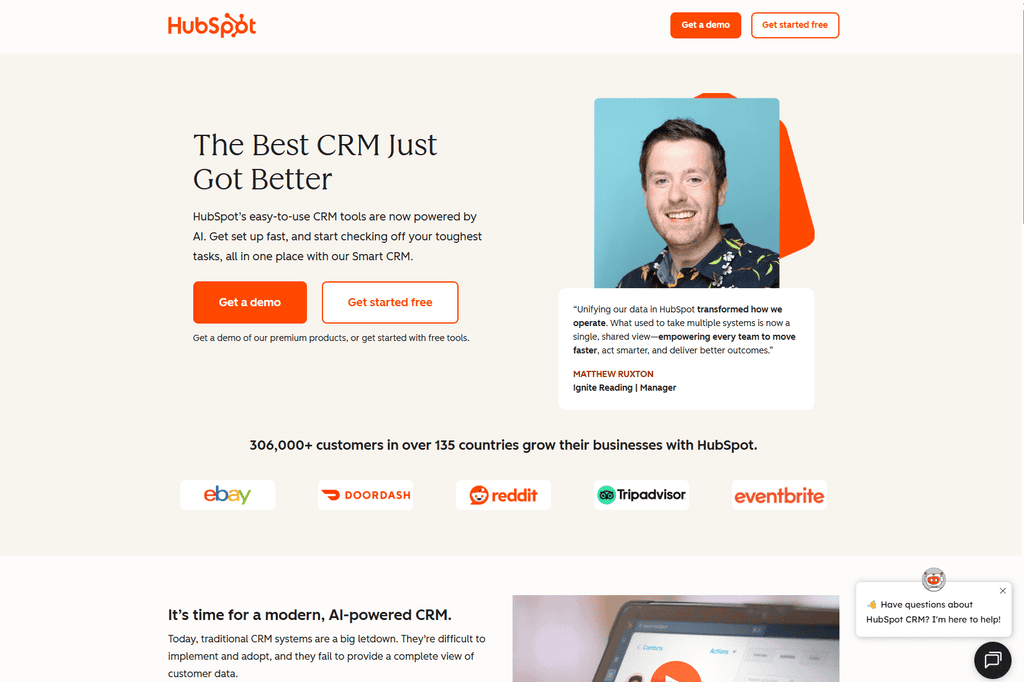 Screenshot of the HubSpot homepage with the headline "The Best CRM Just Got Better," a customer testimonial, and logos of companies including eBay, DoorDash, and Reddit.