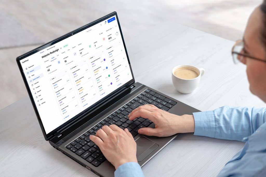 Laptop displaying a project management dashboard with task organization and productivity information